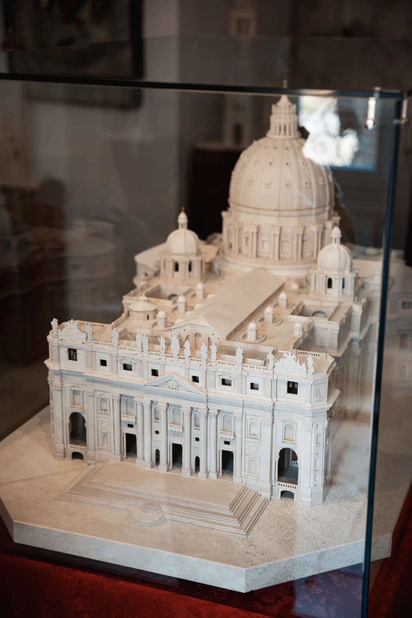 The carved facade and dome of a miniature St. Peter's Basilica.
