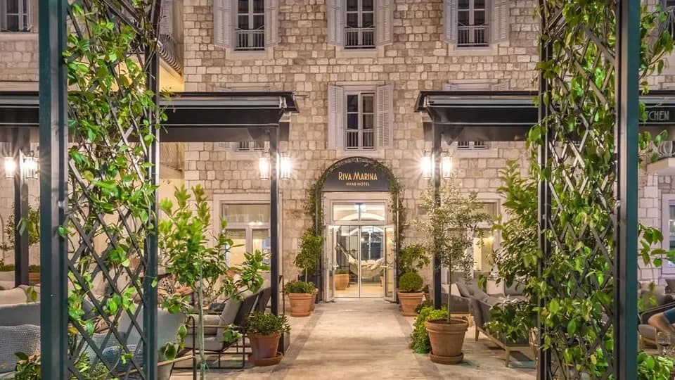The stone entrance and planted terrace of Riva Marina Hvar Hotel.